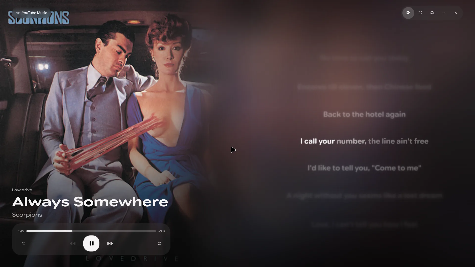 Media mode: the album cover filling the left side, track title and controls below it, and synced lyrics on the right.